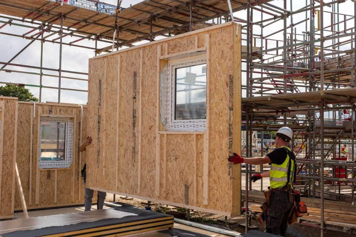 Closed timber panel being craned into position